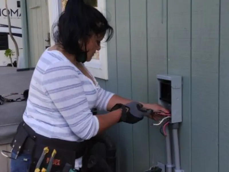 Licensed electrician wiring an exterior subpanel in Georges